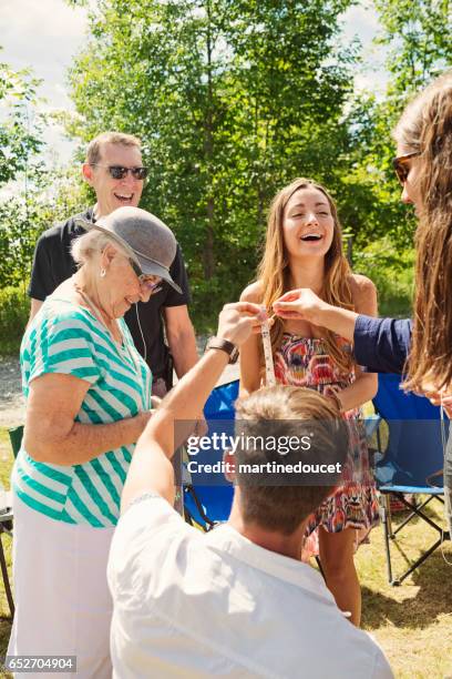 baby shower game; friends and family guessing belly measurements. - guessing game stock pictures, royalty-free photos & images