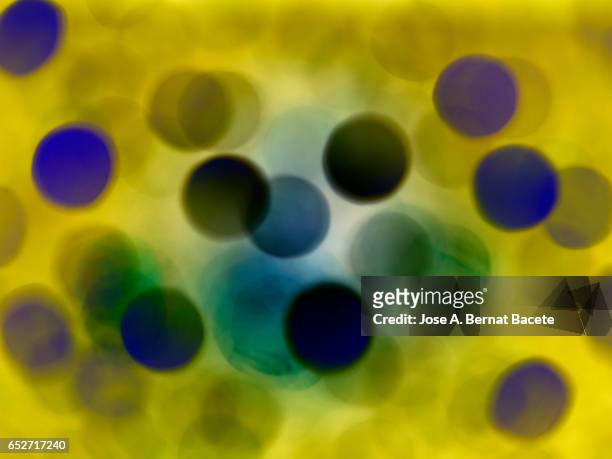 close-up of defocused light in the shape of circles yellow and blue colors - yellow light effect stock pictures, royalty-free photos & images