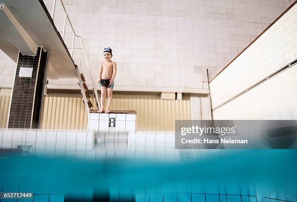 boy preparing to pool dive - boy diving board stock pictures, royalty-free photos & images