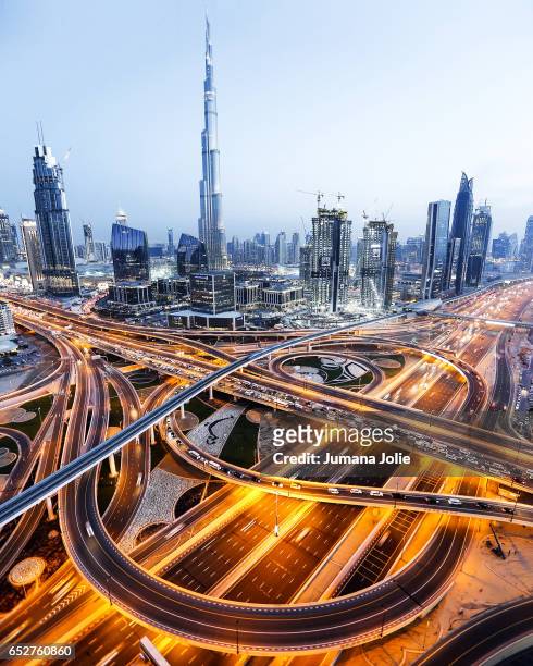 an aerial view of the burj khalifa and highway in dubai - dubai aerial stock pictures, royalty-free photos & images