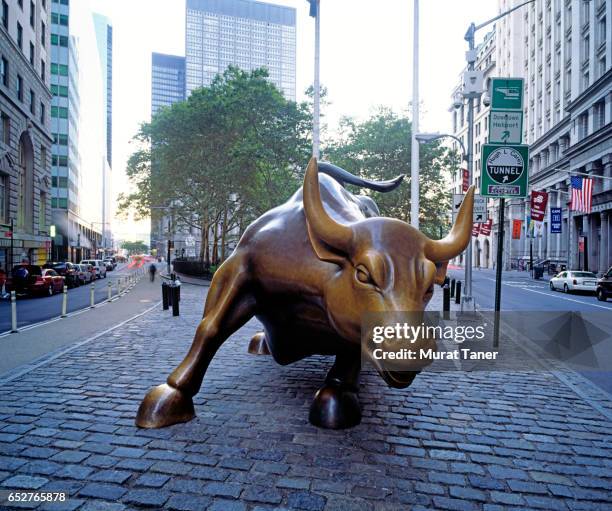 charging bull sculpture near wall street - bull wall street stock pictures, royalty-free photos & images