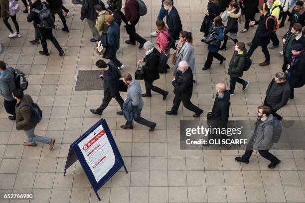 Rail passengers make their way through Manchester Victoria train station during a reduced transport service due to industrial action taken by the RMT...