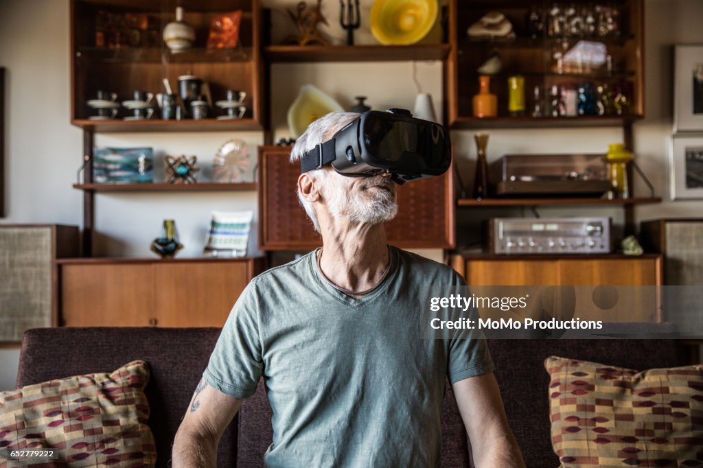 Man (60yrs) wearing virtual reality goggles