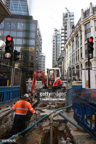 The Lloyds building is seen in the distance as road workers continue their work on the roads in the financial district on March 13, 2017 in London,...