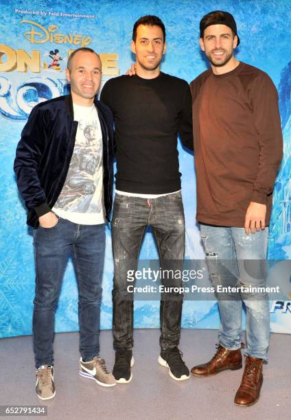 Barcelona football player Andres Iniesta, Sergio Busquets and Gerard Pique attend 'Disney On Ice' on March 10, 2017 in Barcelona, Spain.