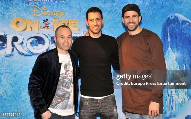 Barcelona football player Andres Iniesta, Sergio Busquets and Gerard Pique attend 'Disney On Ice' on March 10, 2017 in Barcelona, Spain.