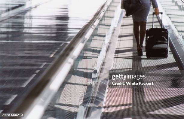 woman on moving walkway - moving walkway airport stock pictures, royalty-free photos & images