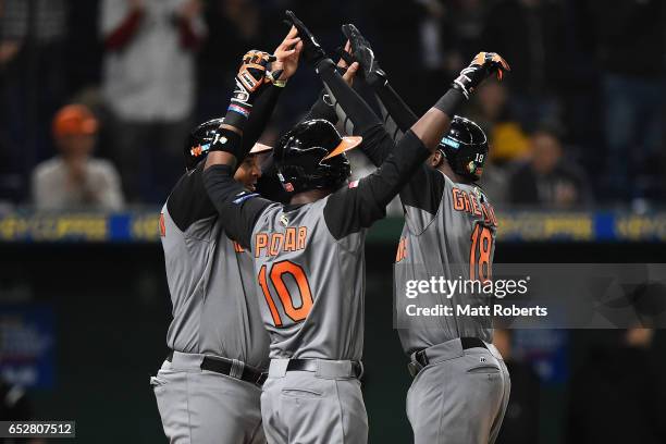 Desingated hitter Didi Gregorius of the Netherlands celebrates with Outfielder Wladimir Balentien and Outfielder Jurickson Profar after hitting a...