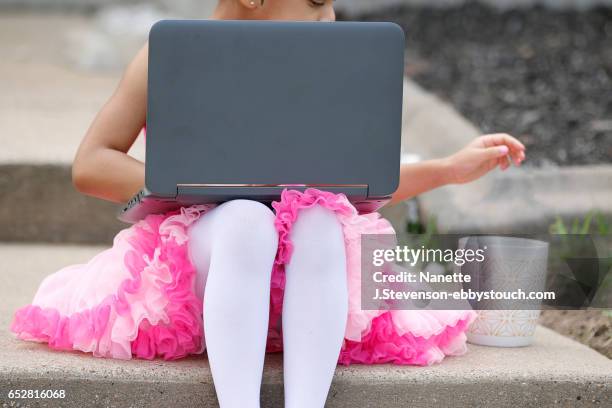 little girl wearing pink tutu with coffee and computer - nanette j stevenson ストックフォトと画像