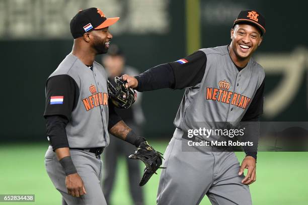 Infielder Yurendell de Caster and Infielder Jonathan Schoop of the Netherlands smile after the bottom of the seventh inning during the World Baseball...