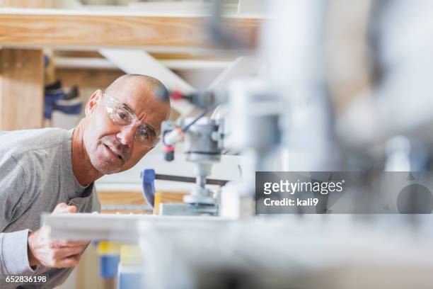 senior man working in shutter factory on machinery - bespoke stock pictures, royalty-free photos & images