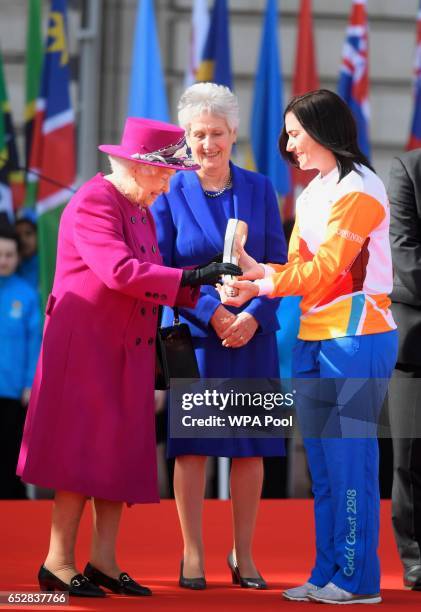 Retired cyclist Anna Mears from Australia receives the baton from Queen Elizabeth during the launch of The Queen's Baton Relay for the XXI...