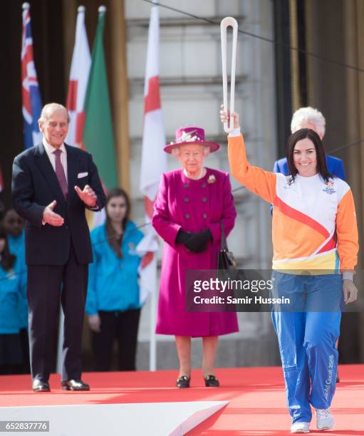 Anna Meares carries the Commonwealth baton as Queen Elizabeth II and Prince Philip, Duke of Edinburgh look on during the launch of The Queen's Baton...