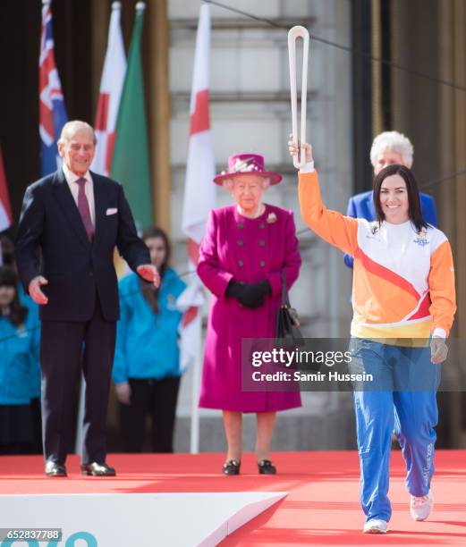 Anna Meares carries the Commonwealth baton as Queen Elizabeth II and Prince Philip, Duke of Edinburgh look on during the launch of The Queen's Baton...