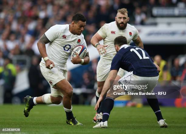 Nathan Hughes of England charges towards Alex Dunbar of Scotland during the RBS Six Nations match between England and Scotland at Twickenham Stadium...