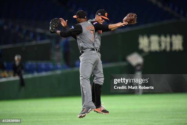 Infielder Yurendell de Caster and Infielder Xander Bogaerts of the Netherlands celebrate their 12-2 victory in the World Baseball Classic Pool E Game...