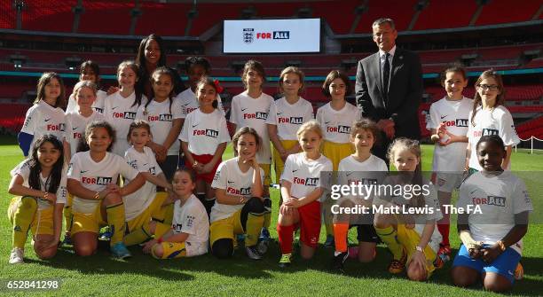 Alex Scott, England Women and Arsenal Ladies footballer and Martin Glenn, Football Association Chief Executive pictured with local school children...