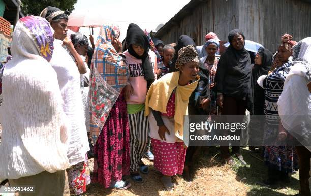 Local residents mourn after a landslide that swept through a massive garbage dump, killing at least 46 people and leaving several missing at Koshe...