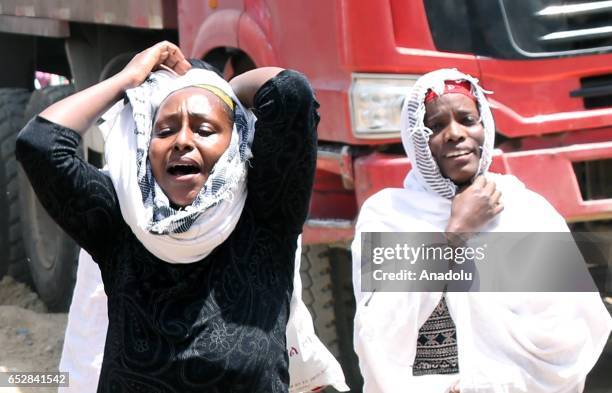 Local residents mourn after a landslide that swept through a massive garbage dump, killing at least 46 people and leaving several missing at Koshe...