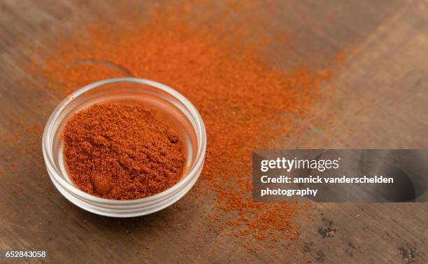 powdered chili pepper in little glass bowl. - pimenta de caiena imagens e fotografias de stock