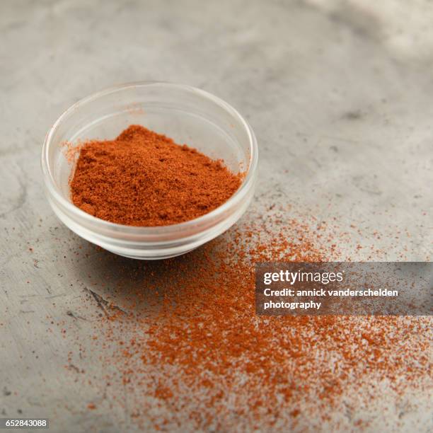 powdered chili pepper in little glass bowl. - cayenne pepper stock pictures, royalty-free photos & images