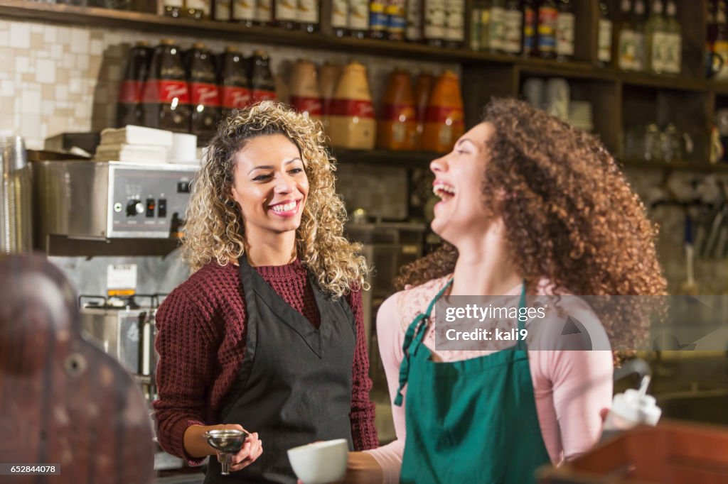 Two young women working in coffee shop