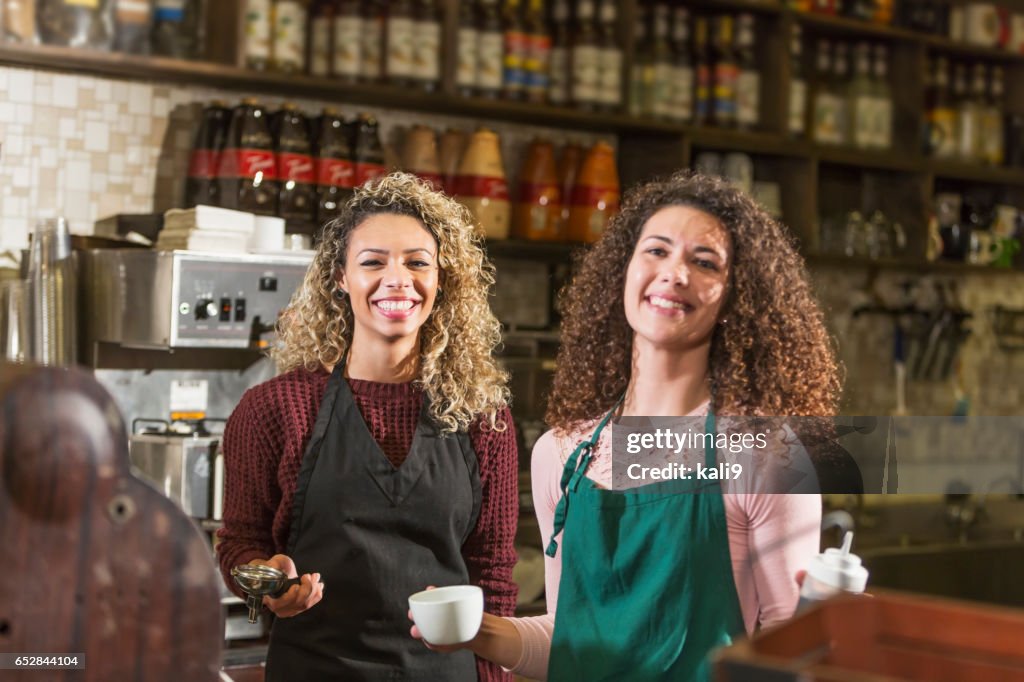 Two young women working in coffee shop