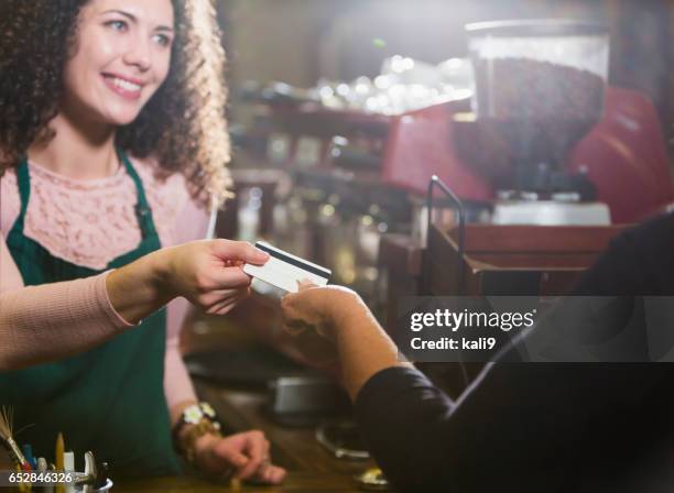 cashier in coffee shop takes payment card from customer - gift card stock pictures, royalty-free photos & images