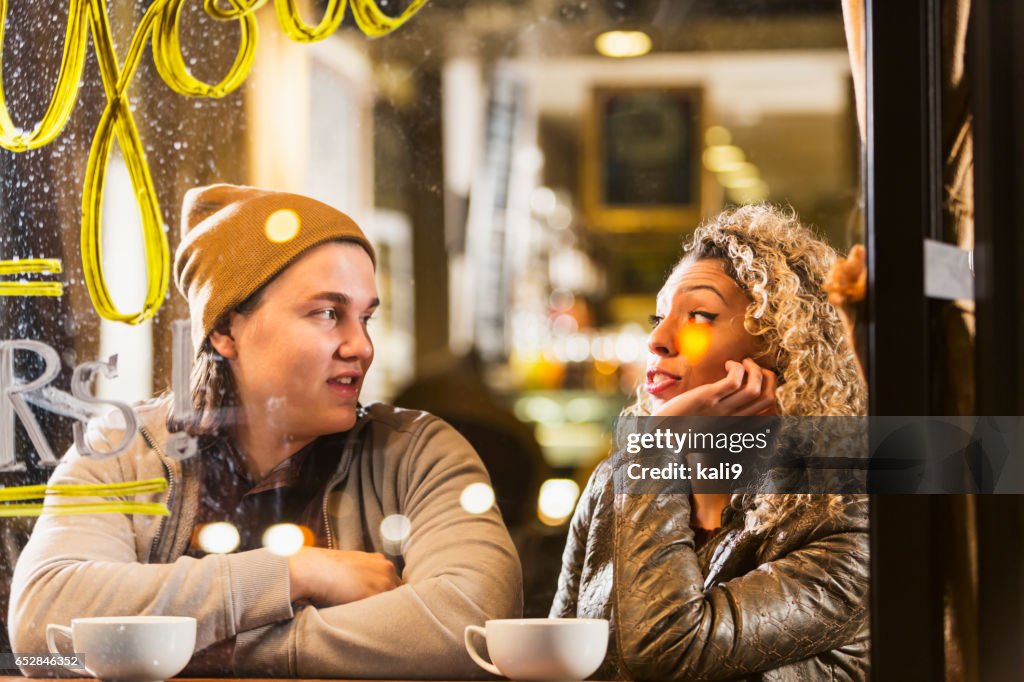 Junges Paar sitzt im Café im Gespräch