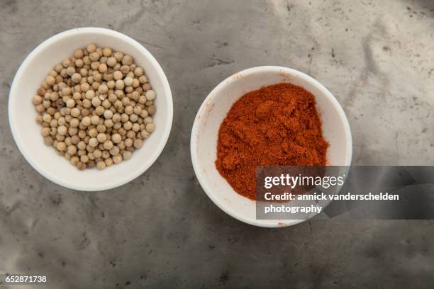 white peppercorns and red pepper. - cayenne powder stock pictures, royalty-free photos & images