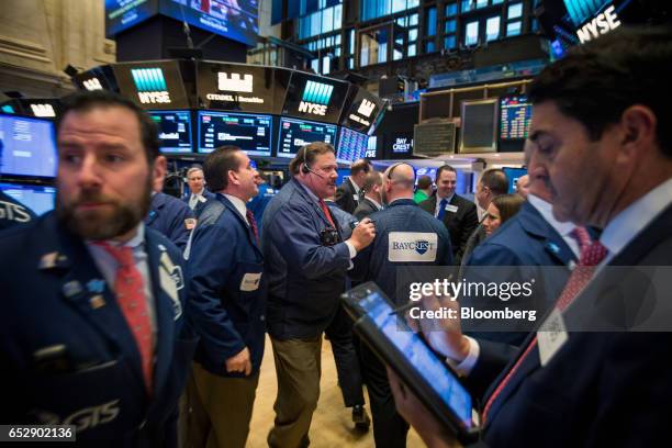 Traders work on the floor of the New York Stock Exchange in New York, U.S., on Monday, March 13, 2017. U.S. Stocks held steady as they kicked off a...