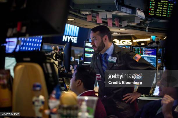 Traders work on the floor of the New York Stock Exchange in New York, U.S., on Monday, March 13, 2017. U.S. Stocks held steady as they kicked off a...