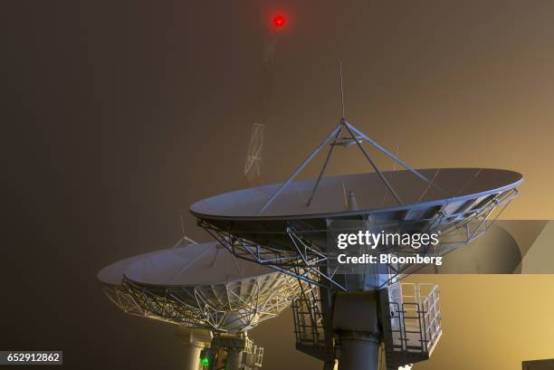 Satellite antennas stand illuminated at night at the Bolivian Space Agency Amachuma Ground Station in Achocalla, La Paz Department, Bolivia, on...