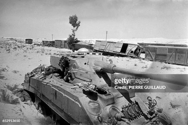 Destroyed tank and train are seen on the road in the Sinai Peninsula, in June 1967 during the 1967 Arab-Israeli war. On 05 June 1967, Israel launched...