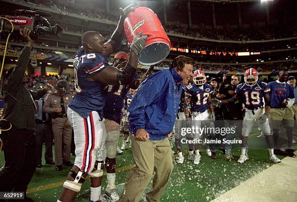 Menyatta Walker of the Florida Gators dumps ice on Head Coach Steve Spurrier after the game against the Auburn Tigers at the Georgia Dome in Atlanta,...