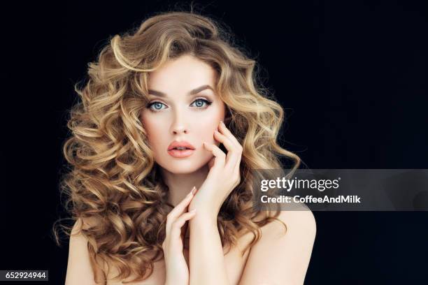 blonde woman fashion model posing against black background - blonde hair black background stock pictures, royalty-free photos & images