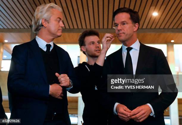 Netherlands' far-right politician Geert Wilders of the PVV party and Netherlands' prime minister Mark Rutte of the VVD Liberal party prepare to...