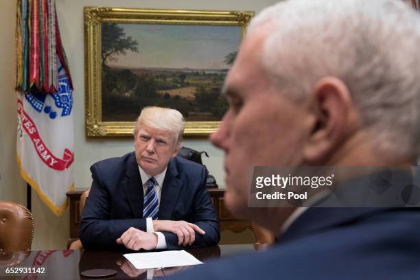 President Donald Trump and Vice President Mike Pence attend a meeting on healthcare in the Roosevelt Room of the White House on March 13, 2017 in...