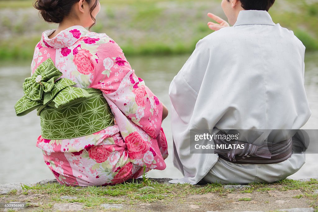 Japanese couples sit in river beach