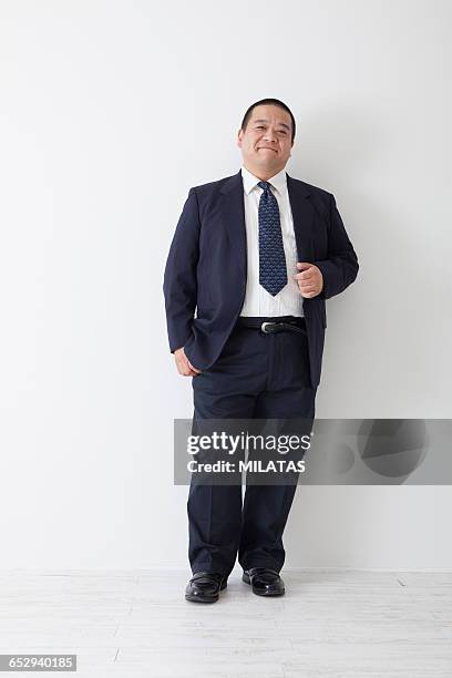 middle-aged of japanese man wearing a suit - fat man in suit stock pictures, royalty-free photos & images