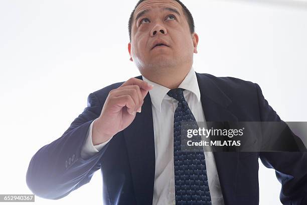 middle-aged of japanese man wearing a suit - fat man in suit stock pictures, royalty-free photos & images