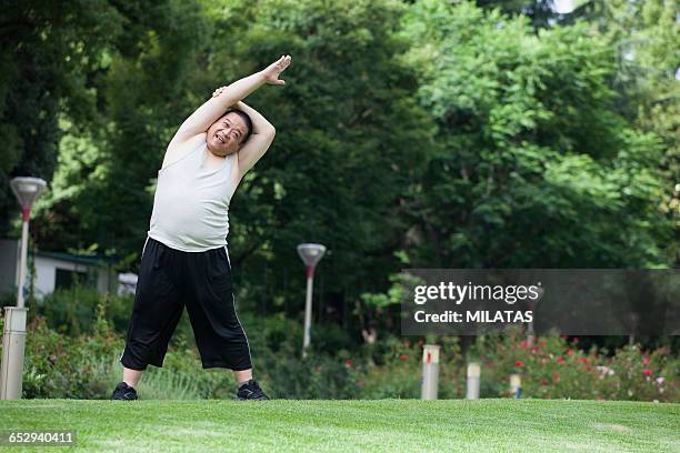 middle-aged of japanese men who exercise in the park - elastic connective tissue stock pictures, royalty-free photos & images
