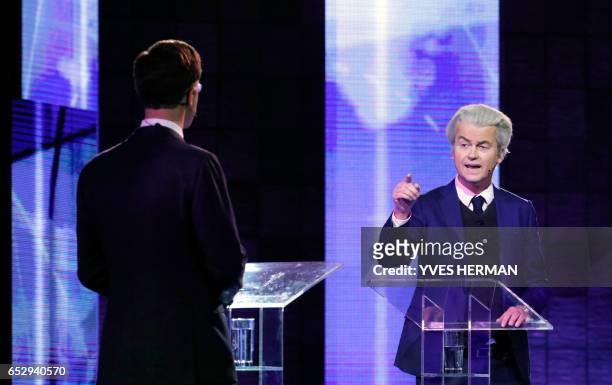 Netherlands' far-right politician Geert Wilders of the PVV party gestures while debating Netherlands' prime minister Mark Rutte of the VVD Liberal...