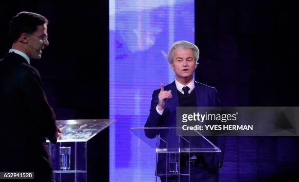 Netherlands' far-right politician Geert Wilders of the PVV party gestures while debating Netherlands' prime minister Mark Rutte of the VVD Liberal...