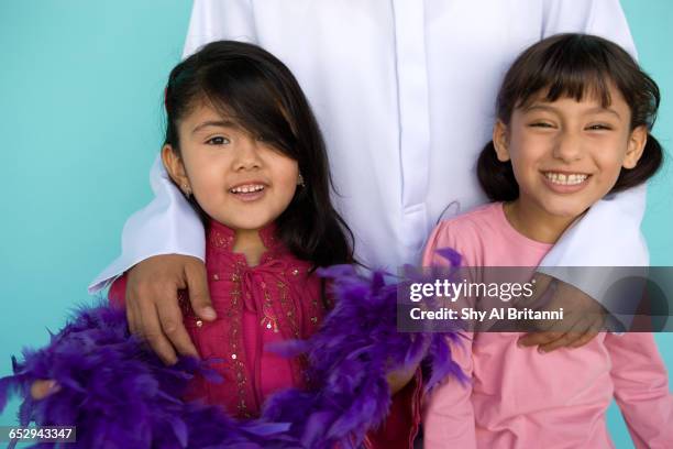 two little girls with their father. - parental guidance stock pictures, royalty-free photos & images