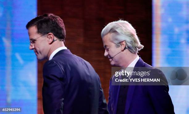 Netherlands' far-right politician Geert Wilders of the PVV party shakes hands with Netherlands' prime minister Mark Rutte of the VVD Liberal party...