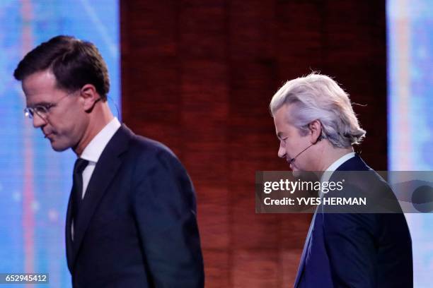 Netherlands' far-right politician Geert Wilders of the PVV party shakes hands with Netherlands' prime minister Mark Rutte of the VVD Liberal party...