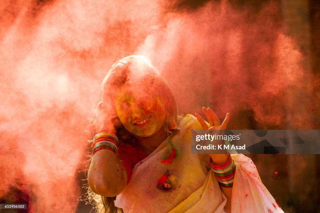 A woman with color powder attend celebrate the Holi Festival...