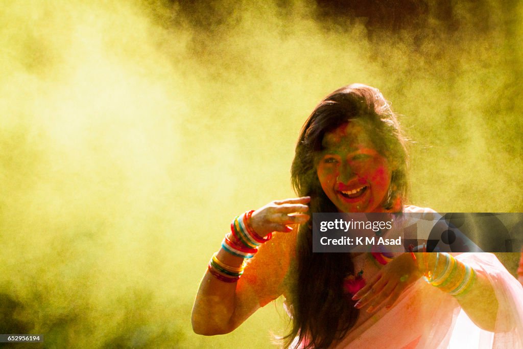 A girl with color powder attend celebrate the Holi Festival...