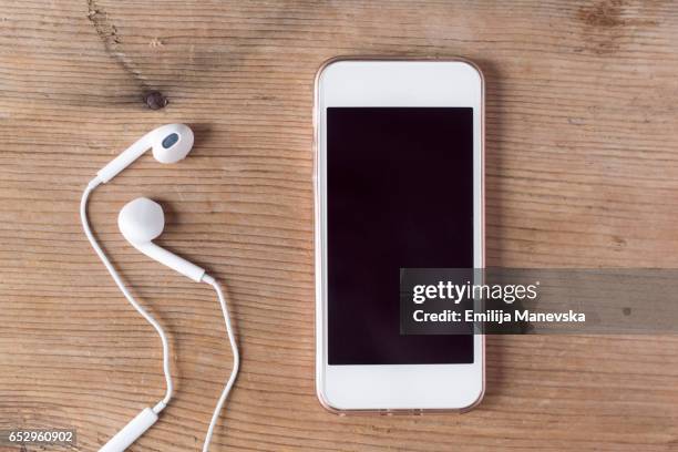 mobile phone and earphones - mp3 player stock pictures, royalty-free photos & images
